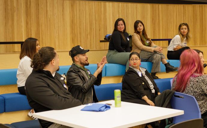 An audience member of an event speaking and others around them listening.